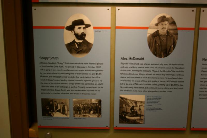 2007-09-03 11:21:50 ** Seattle ** Soapy Smith

Jefferson Randolph 'Soapy' Smith war einer der berüchtigsten Leute des Klondike Goldrausches. Er erreichte Skagway im Oktober 1897 mit einer Bande Betrügern. In einem seiner berühmtesten Betrügereien wurden Neuankömmlinge von Männern begrüßt, die für $5,00 anboten, ein Telegramm an ihre Familien zu schicken. Allerdings endete die 'Telegraphenleitung' einige Meter hinter seinem Büro. Müde von Soapys Tricks gründeten die führenden Einwohner eine Bürgerwehr, um die Stadt vom kriminellen Element zu reinigen. Soapy Smith wurde am 8. Juli 1898 konfrontiert und bei einem Schußwechsel getötet. In erster Linie bleibt er für seine illegalen Aktivitäten in Erinnerung. Er wird von einigen allerdings auch für seine Großzügigkeit gegenüber wohltätigen Zwecken, der Kirche und denen in Not erinnert.

Alex McDonald

'Big Alex' McDonald war ein großer, komischer, schüchterner Mann. Er redete langsam und konnte weder Lesen noch Schreiben. Trotzdem wurde er zu einem von Klondikes reichsten Männern und kam zu dem Spitznamen 'König des Klondike'. Er machte ein Vermögen ohne jemals selber die Schaufel zu heben. Er kaufte vermeintlich wertlose Rechte und beschäftigte andere, diese Rechte zu bearbeiten. Er kaufte das Recht 30 Eldorado für einen Sack Mehl und etwas Speck. 30 Eldorado wurde eines der erfolgreichsten Rechte am Eldorado und verdiente etwa $5.000 pro Tag. Er hätte sich damit ohne Probleme zur Ruhe setzen können aber kaufte weiter Rechte und Land, vieles davon wertlos. Wie viele andere Goldsucher auch starb er pleite.